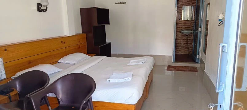 Cozy and peaceful retreat bedroom with comfortable wooden double bed and en-suite bath
