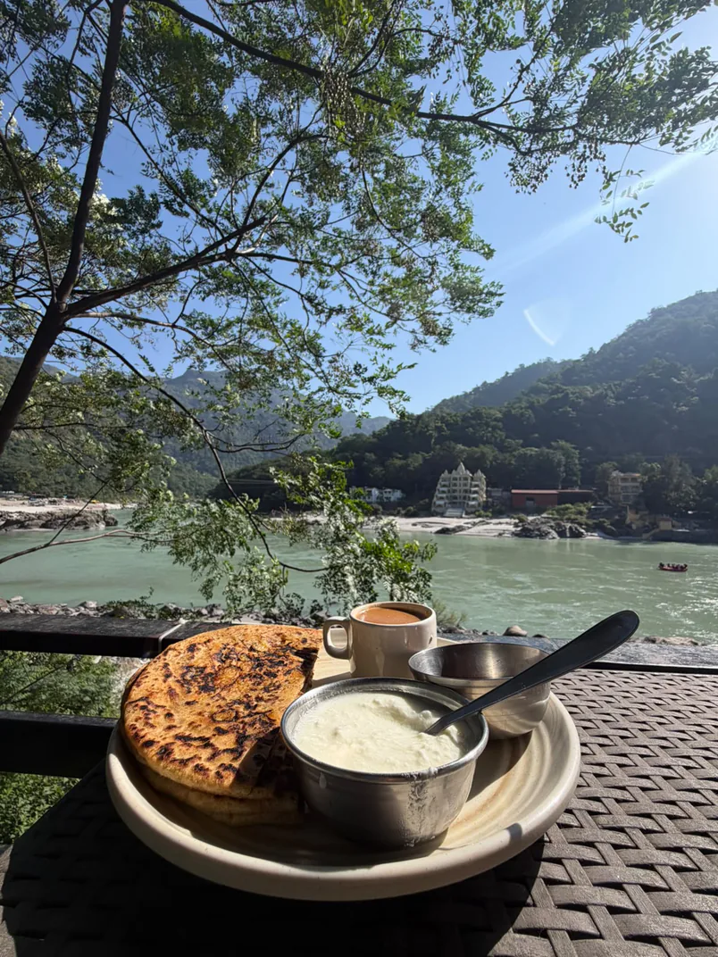 Freshly prepared breakfast and tea overlooking the turquoise waters of the Ganga
