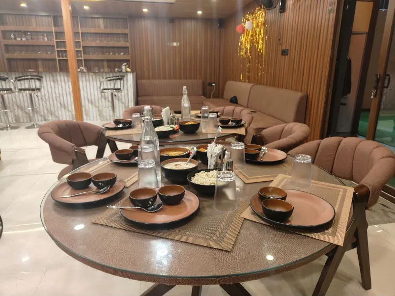 Warm wooden dining hall arranged for mindful retreat meals